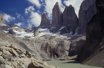 CHILE, Torres Del Paine, Parque Nacional, Hikers resting on hillside above a river and below