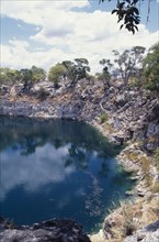 NAMIBIA, Damara, Lake Otjikoto, Sink Hole formed from collapsed cavern with rocky surround