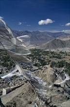 INDIA, Ladakh Region, Leh Valley, Prayer Flags flying over Leh surrounded by mountain range.