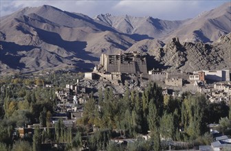 INDIA, Ladakh, Leh, Hillside palace overlooking the town surrounded by mountainous terrain