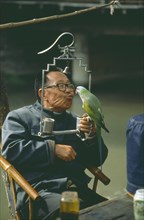 CHINA, People, Old Man in Cafe with Pet Parrot