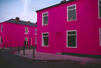 ENGLAND, Greater Manchester , Salford , Terrace houses on Ash Street painted shocking pink with