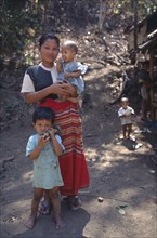 THAILAND, North, Mae Sai Area, Karen refugee mother with children
