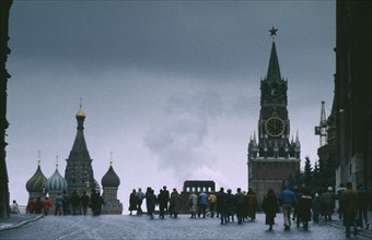 RUSSIA,  , Moscow, Red Square in winter with crowds and spires of St Basils Cathedral and clock