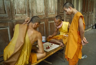 THAILAND, Bangkok , Buddhist Monks playing chess in Bangkok monastery.