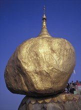 MYANMAR, Pegu, Kyaiktiyo, Pilgrims at the Golden Rock Pagoda a precariously perched head shaped
