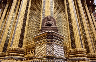 THAILAND, Bangkok, "Grand Palace, Wat Phra Kaeo. Seated Buddha statue with ornately decorated