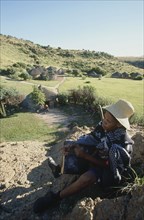 SOUTH AFRICA, Qwa-Qwa, Basotho Village, "Basotho Cultural Village, local man playing an instument