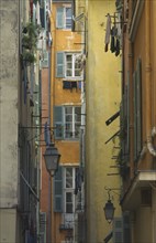 FRANCE, Prov Cote D’Azur  , Nice, Old Port Area narrow alley way with flat windows and washing