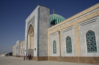 UZBEKISTAN, Near Samarkand, Al Bukhari Mausoleum. Exterior view along the facade with people at the