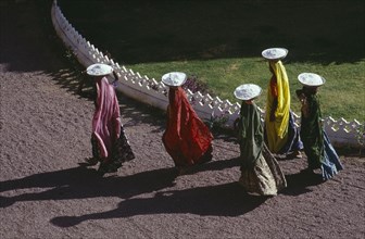 10123374 INDIA Rajasthan Devargh Aerial view over female construction workers carrying building materials on their heads.