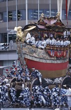 JAPAN, Honshu, Kyoto, Gion festival float being pulled along the street