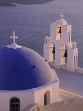 GREECE, Cyclades Islands, Santorini, Thira detail of blue and white church dome and bell tower at
