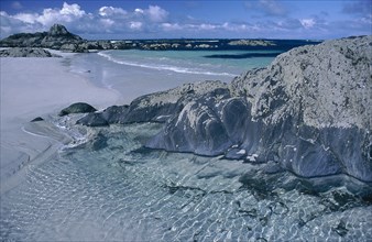SCOTLAND, Isle Of Iona, White sandy beach with rocks and clear blue water