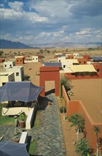 NAMIBIA, Namib Desert, Sussusvlei, Karos Lodge. View over cluster of Hotel buildings on the edge of