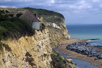 CLIMATE, Erosion, House on the edge of an eroded cliff at Fairlight in Sussex caused by severe