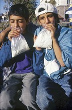 BULGARIA, Sofia, Two gypsy boys sniffing glue from plastic bags