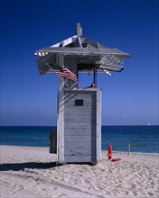 USA, Florida, Fort Lauderdale, Lifeguard Hut on sandy beach with American flag flying