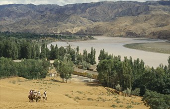 CHINA, Ningxia , Yellow River, "View over river bend in sandy region of north west China.  Group of