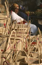 SOUTH AFRICA, KwaZulu-Natal, St.Lucia Village, Zulu woman selling hand woven baskets made from Lala