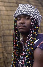 SOUTH AFRICA, KwaZulu Natal, Melmoth, Young Zulu man with colourful beaded hair decoration
