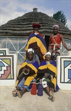 SOUTH AFRICA, KwaZulu Natal, Mpumalanga, Ndebele women in traditional dress outside the arts and