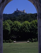 PORTUGAL, Estremadura, Sintra , Pena Palace seen in the distance through an arch in the gardens of
