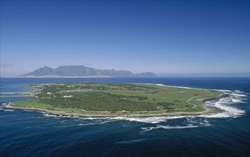 SOUTH AFRICA, Western Cape, Robben Island, Aerial view of the prison island with table Mountain in