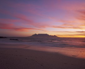 SOUTH AFRICA, Cape Province, Cape Town, View of Table Mountain at dusk taken from Bloubergstrand