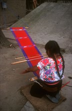MEXICO, Chiapas, Zinacantan , Near San Cristobal.  Woman weaving.