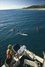 MOZAMBIQUE, Magaruque Island,  Tourists snorkelling from dive boat.