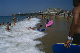 FRANCE, Aquitaine, Pyrenees Atlantiques, Biarritz.  Busy beach scene with children playing in the