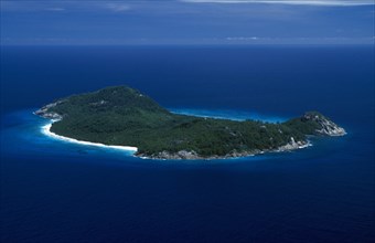 SEYCHELLES, North Island, Aerial, View over whole Island with white sand beach and interior covered