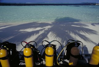 MALDIVES, Nika Island, Looking out to sea with scuba diving tanks on the beach in the shadow of