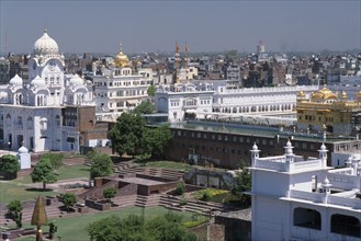 INDIA, Punjab, Amritsar , Golden Temple complex and surrounding city buildings.
