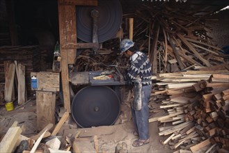 BOLIVIA, Tarija, Man working in saw mill.