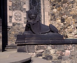 SCOTLAND, Lothian, Edinburgh, Holyrood House. Stone statue of lion holding shield next to steps