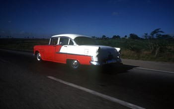 CUBA, Pinar Del Rio, Transport, Old red and white coloured 1950s US car