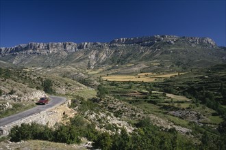 SPAIN, Pyrenees, Catalonia, Cerdana Valley in the foothills of the Pyrenees with car parked on road