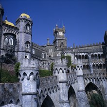 PORTUGAL, Estremadura, Sintra, Pena Palace. View  from castle walls with clock tower and blue sky