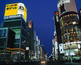 JAPAN, Honshu, Tokyo, "Ginza at night, view along road with illuminated signs/bldgs "