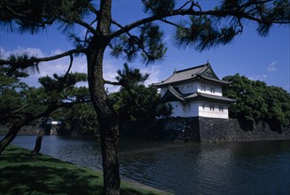 JAPAN, Honshu, Tokyo, Imperial Palace seen across the moat with pine trees in the foreground