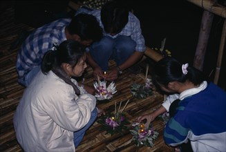 THAILAND, Chiang-Mai  Festival, "'Yipeng' Loi Krathong Festival, Lighting candles on Krathong to be