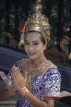 THAILAND, Bangkok, Female Temple dancer in traditional dress outside Grand Hyatt Erawan Hotel