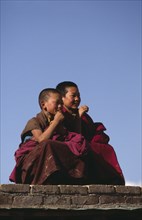 CHINA, Qinghai , Festivals, Young monks watching Tibetan festival.