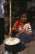 THAILAND, North, Mae Sariang, Karen refugee woman in Mae Lui village preparing Soya in a pot