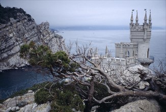UKRAINE, Yalta, The Swallows Nest. Small castle with high tower built on a cliff edge over the sea
