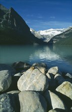 CANADA, Alberta, Banff National Park, Lake Louise with chipmunk on rock in foreground.