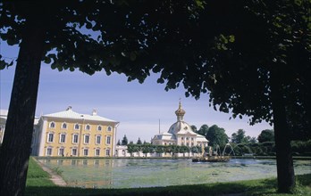 RUSSIA,  , St Petersburg, Puskin palace viewed from under tree branches