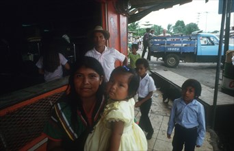 PANAMA, General, Guayami Indian family standing at counter with truck in the background